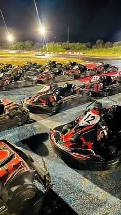 several go karts lined up on the track at night