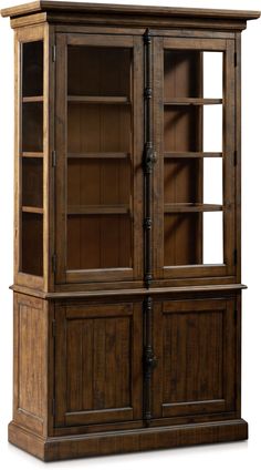 a wooden bookcase with glass doors on the top and bottom shelves, in dark wood