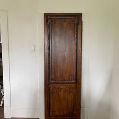 an old wooden door in the corner of a room