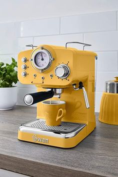 a yellow coffee machine sitting on top of a counter