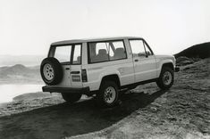 a black and white photo of a four door jeep