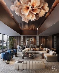 a living room filled with lots of furniture and large flowers hanging from the ceiling above