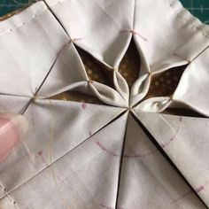 someone is working on an origami piece that has been made into a flower