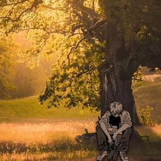 a person sitting under a tree with their head on the ground, in front of an open field