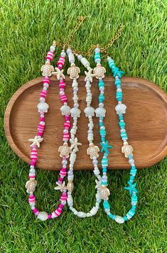 This beautiful coastal-themed beaded necklace is a stunning addition to your summer accessories. This necklace is made of fun tropical beads. Beads vary from being made out of plastic, acrylic, polymer clay, glass, and resin. The string is made out of a non-stretch elastic cord. This necklace is about 15 inches in length. This length can be increased by anywhere from 0.1 inches to (at max) 2.75 inches. The extender chain is 2.75 inches in length. This necklace can be closed by its gold-plated lo Summer Ocean-inspired Beaded Necklaces, Ocean-inspired Beaded Necklace For Summer, Beach Shell Necklaces With Tiny Beads, Multicolor Beachy Beaded Necklaces For Vacation, Beachy Multicolor Beaded Necklaces For Vacation, Blue Beachy Beaded Necklace For Vacation, Beachy Blue Beaded Necklaces For Vacation, Colorful Beaded Shell Necklaces For Vacation, Blue Beaded Necklace For Beach Vacation