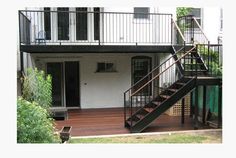 a house with a deck and stairs leading up to the front door