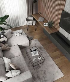 a living room filled with furniture and a flat screen tv on top of a wooden floor