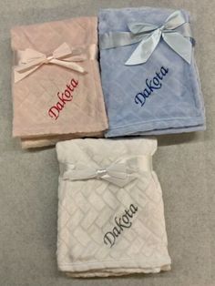 three personalized blankets with bows on them