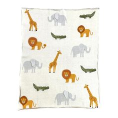 an animal themed pillow with elephants, giraffes and crocodiles