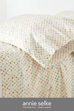 an image of a bed with polka dot sheets