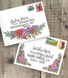 two envelopes with stamps on them sitting next to each other, one is decorated with flowers