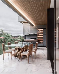 a dining room table with chairs and a dog laying on the floor next to it