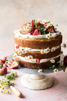 a cake with white frosting and strawberries on top