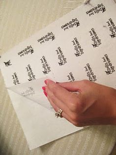 a woman's hand on top of some white paper with black writing and an arrow