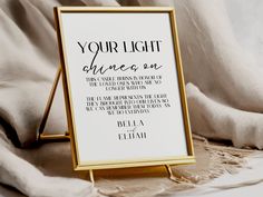 a white and gold framed sign with the words your light shines on it