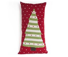 a red pillow with a green and white christmas tree on it