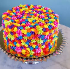 a multicolored cake sitting on top of a table