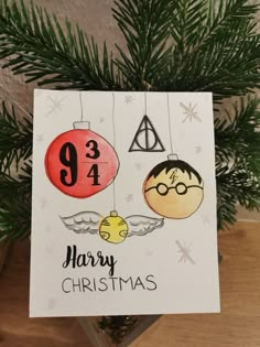 an ornament hanging from a christmas tree with harry potter and his bauben