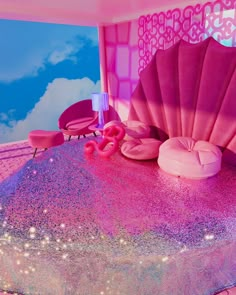 there is a pink and purple cake with an ocean theme on the top that looks like it was made out of glitter