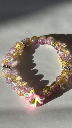 This bracelet has a 6.5 to 7in circumference (depends on what base you want.) The stones used are glass with your choice of silver or gold spacers lined with cubic zirconia, or  just faux pearl by its self. The band is made of elastic. the flowers are made of clay. there's an option under personalization to leave me a note of what you do or do not want, otherwise I will pick the flower at random. (very limited color options so what you want may not be available). Disclaimer: This product contains small parts that may pose a choking hazard for young children. Please exercise caution and supervise its use around children. The Flowers, Faux Pearl, Color Options, Cubic Zirconia, Jewelry Bracelets, Etsy Accessories, Accessory Gift, Beaded Bracelets, Gift Card