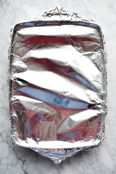 aluminum foil wrapped in red, white and blue strips sitting on a marble counter top