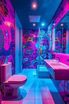 a brightly lit bathroom with pink and blue lighting