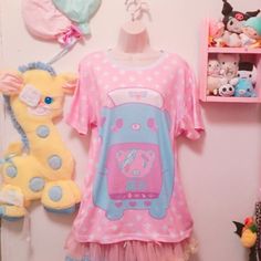 "Is a nurse bear taking care of her patient. The word in japanese means \"PAIN\" This new all over print t-shirt features a relaxed fit for Cuties. Made of 100% mesh cloth, this t-shirt is durable, breathable and soft. * 7.05 Oz. 100% polyester. * Double-needle hemmed sleeves and bottom. * Machine wash cold. The print on garment body is unable to fade. Color may appear different in the photo. Thank you'ω ♥ ☆ ★ ♪ Model by: katiebabydoll" Playful Pink Short Sleeve T-shirt, Casual Graphic Print T-shirt For Pajama Party, Casual Crew Neck T-shirt For Bedtime, Harajuku Style Printed Short Sleeve Tops, Pink Short Sleeve Top For Bedtime, Pink Printed Short Sleeve T-shirt, Pink Graphic Print Top For Pajama Party, Pink Printed Short Sleeve Sleepwear, Pink Short Sleeve T-shirt For Pajama Party