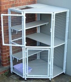 a tall white shelf with several shelves on the top and bottom, in front of a brick wall