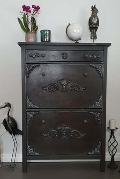 a black dresser with ornate carvings on it