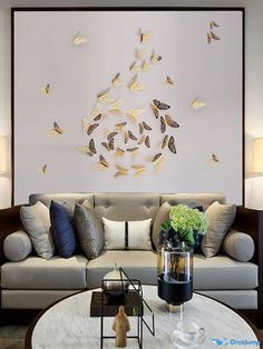 a living room filled with furniture and lots of butterflies on the wall