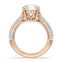 a rose gold engagement ring with an oval center stone and pave set side stones