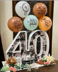 a table topped with balloons and an 40 sign