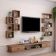 there is a television on the wall in this living room with wooden shelves and toys