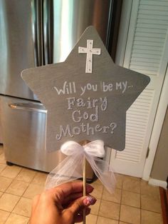 someone holding up a star shaped sign with the words will you be my fairy god mother?