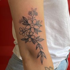 a woman with a flower tattoo on her arm