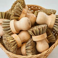 a basket filled with lots of different types of hair brushes on top of each other