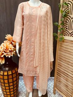 Embrace elegance with Anandi Fashions' exquisite 3 piece Organza Chudidhar set/Kurti set in peach color, crafted to perfection for size 40/US S. This stunning ensemble includes a finely detailed kurti, comfortable chudidhar, and an ethereal dupatta, all made from premium organza fabric that radiates sophistication. Ideal for any festive occasion or cultural gathering, the delicate peach color adds a touch of grace and charm to your wardrobe. At Anandi Fashions, we pride ourselves on delivering high-quality Indian ethnic wear that celebrates tradition and craftsmanship. Enhance your ethnic collection with this versatile and timeless piece, reflecting our commitment to style and cultural heritage. Elegant Beige Palazzo Set For Diwali, Peach Palazzo Set With Resham Embroidery, Beige Dupatta For Diwali, Elegant Peach Palazzo Set For Festive Occasions, Elegant Peach Anarkali Set For Designer Wear, Elegant Designer Peach Anarkali Set, Elegant Peach Sharara With Traditional Drape, Fitted Peach Sharara With Sheer Dupatta, Elegant Orange Sharara For Diwali