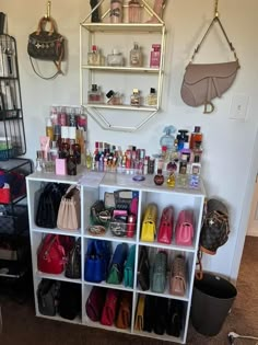 a white shelf filled with lots of purses and handbags on top of it