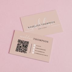 two business cards sitting next to each other on top of a pink surface with qr code