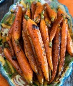 a plate full of cooked carrots on a table