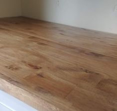 a wooden counter top in an empty room