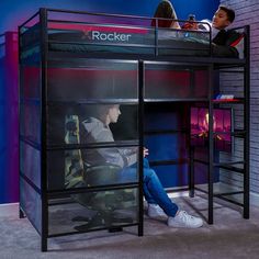 two children are sitting on bunk beds in a room with blue walls and purple lighting