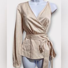 This Bcbgmaxazria Wrap Top Features A Single Long Sleeve, An Adjustable Shoulder Strap And A Tie Closure At The Waist. Style V-Neck; Tie Closure At The Waist Brand: Bcbgmaxazria Size: Xxs Condition: New With Tags. Color: Beige Pattern: Solid Material: 60% Viscose, 40% Polyester Care: Hand Wash Approx. Measurements (Flat): Bust: 17" Sleeve: 25" Length: 25" Across The Bottom: 21" Chic Long Sleeve Wrap Top For Party, Spring Evening Wrap Top With Long Sleeves, Beige Long Sleeve Evening Blouse, Beige Long Sleeve Blouse For Evening, Elegant Wrap Top For Brunch, Elegant Faux Wrap Blouse For Party, Chic Evening Faux Wrap Top, Chic Fall Wrap Top For Brunch, Spring Formal Wrap Blouse