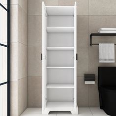 an empty white cabinet in a bathroom next to a trash can and towel dispenser