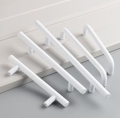 three white handles and four hooks on the wall