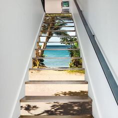 stairs leading up to the beach with palm trees