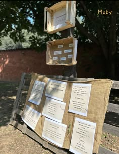 several pieces of paper are stacked on top of each other in front of a tree