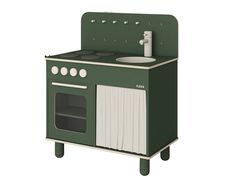 a green and white stove top oven sitting next to a wall mounted faucet