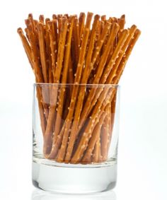 a glass filled with crackers sitting on top of a table