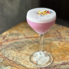 a pink and white drink sitting on top of a table